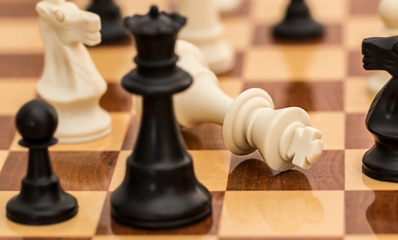 Close-up of chess pieces on a board depicting strategy and challenge.