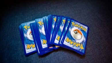 High angle of set of trading cards with images of fictional creatures placed against gray background