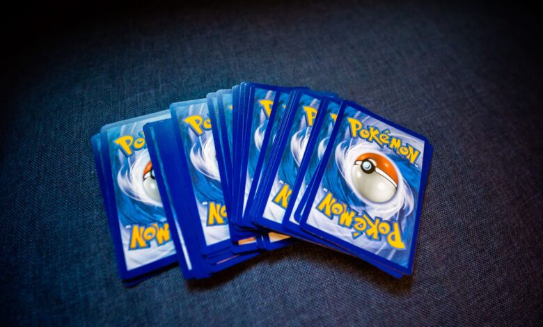 High angle of set of trading cards with images of fictional creatures placed against gray background
