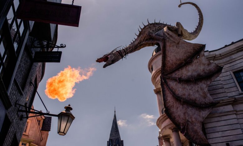 Stunning dragon sculpture breathing fire at a themed street in Orlando, Florida.