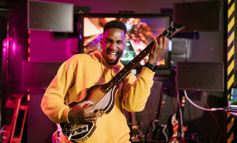 A cheerful adult playing Guitar Hero indoors, exuding excitement and happiness.
