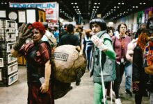 Cosplayers dressed as anime characters at a bustling convention center.