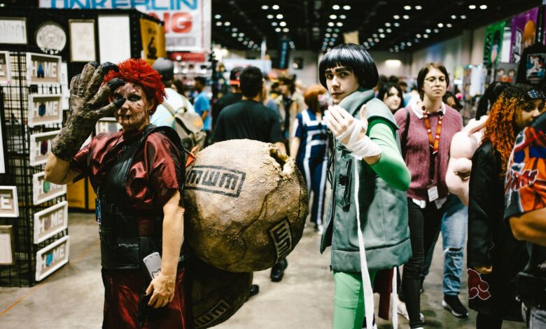 Cosplayers dressed as anime characters at a bustling convention center.