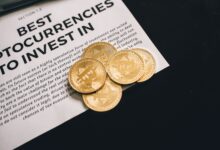 Close-up of Bitcoin coins on investment document promoting cryptocurrencies.