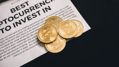Close-up of Bitcoin coins on investment document promoting cryptocurrencies.