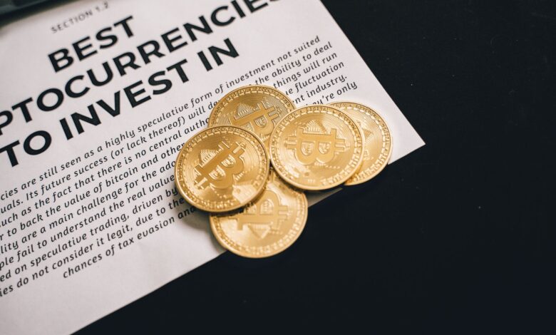 Close-up of Bitcoin coins on investment document promoting cryptocurrencies.