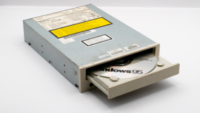 A vintage CD-ROM drive showcasing a Windows 95 disc, reflecting retro technology.