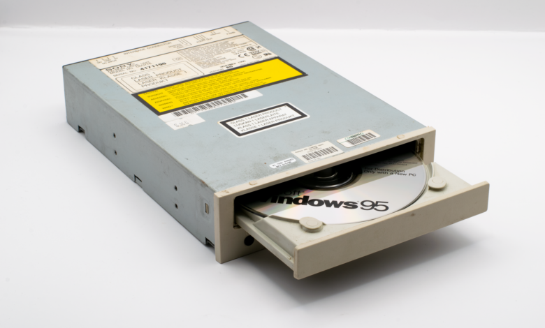 A vintage CD-ROM drive showcasing a Windows 95 disc, reflecting retro technology.