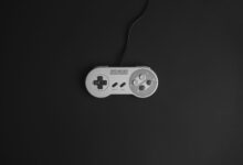 Super Nintendo game controller on a black background, vintage gaming theme.
