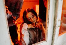 A haunting zombie emerges in a dimly lit room, evoking spine-chilling horror vibes.