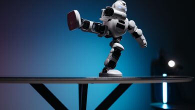A modern robot toy balancing dynamically on one leg, set against a blue gradient background.