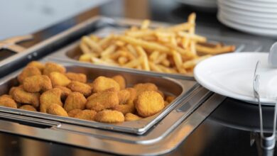 Close-up of crispy nuggets and French fries in a buffet setup, perfect for fast food or catering imagery.