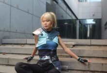 Model poses in futuristic attire on urban steps. Trendy and sleek fashion.