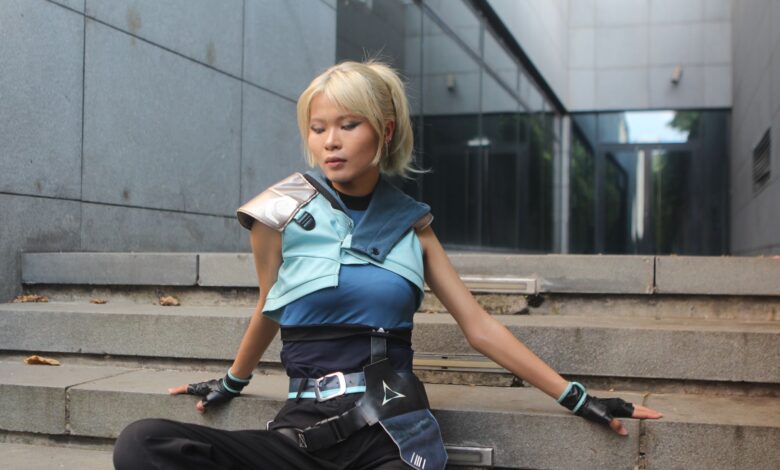 Model poses in futuristic attire on urban steps. Trendy and sleek fashion.