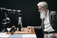 A man plays chess against an AI robotic arm, showcasing technology and strategy innovation.