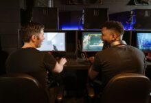 Two men engaged in an exciting gaming session in a modern cyber cafe.