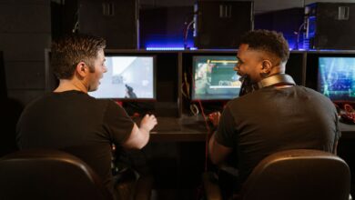 Two men engaged in an exciting gaming session in a modern cyber cafe.