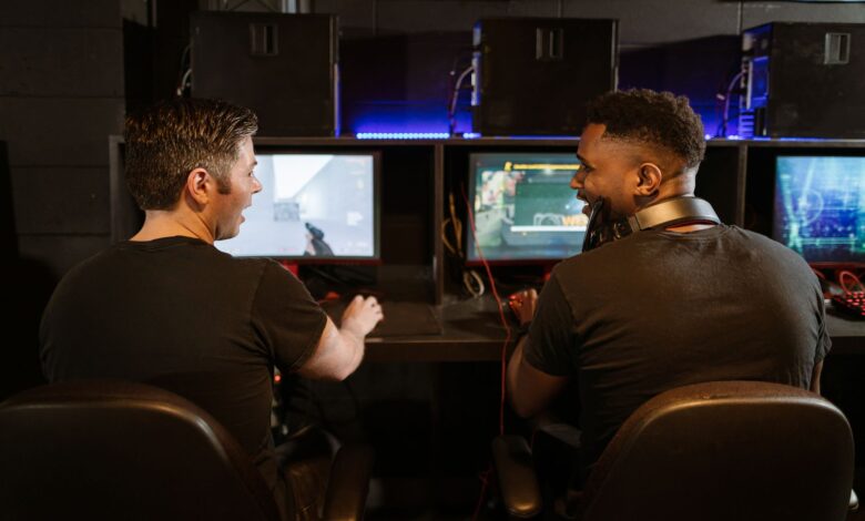 Two men engaged in an exciting gaming session in a modern cyber cafe.