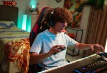 Teenager gaming at home, focused and excited in a modern gaming setup.