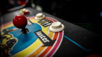 Close-up of a vintage arcade machine control panel with joystick and buttons.