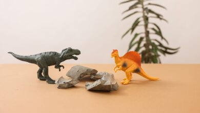 Plastic dinosaur toys on a simple background, creating a playful prehistoric scene.