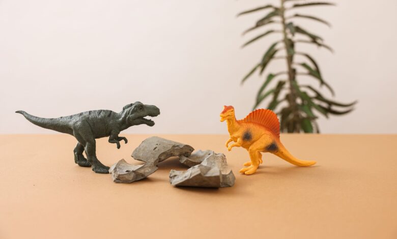 Plastic dinosaur toys on a simple background, creating a playful prehistoric scene.
