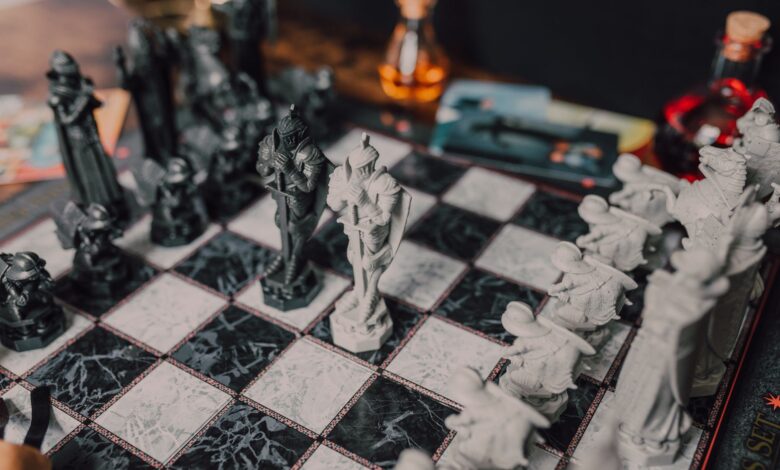 Intricate medieval themed chess set displayed on a marble chessboard. Perfect for strategy enthusiasts.