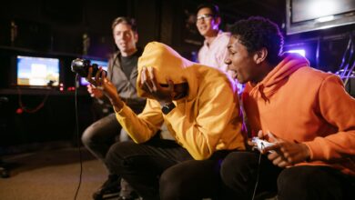 Group of diverse friends enjoying a thrilling video game session indoors. Energetic and fun atmosphere.
