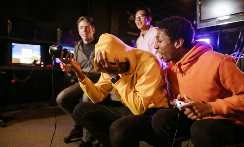Group of diverse friends enjoying a thrilling video game session indoors. Energetic and fun atmosphere.