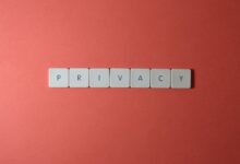 Close-up of letter tiles spelling PRIVACY on a red background, symbolizing data protection.