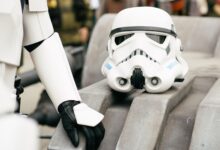 Detailed shot of a stormtrooper helmet and costume in a cosplay event, showcasing sci-fi culture.