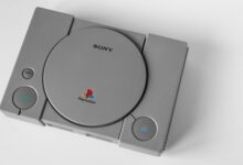 Top view of a vintage PlayStation 1 console on a clean white surface, highlighting its design.