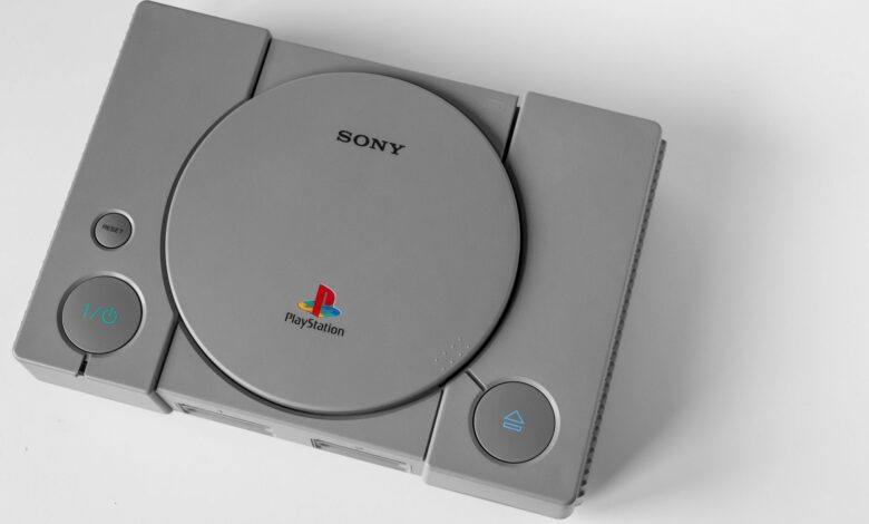 Top view of a vintage PlayStation 1 console on a clean white surface, highlighting its design.