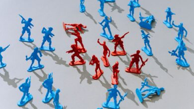 Red and blue toy soldiers on a light surface forming a strategic battle scene.