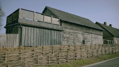 Traditional wooden house alongside a woven fence in Pāvilosta, Latvia.