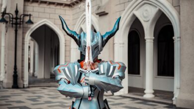 A person in detailed fantasy armor holding a sword in front of an architectural backdrop, creating a dramatic atmosphere.