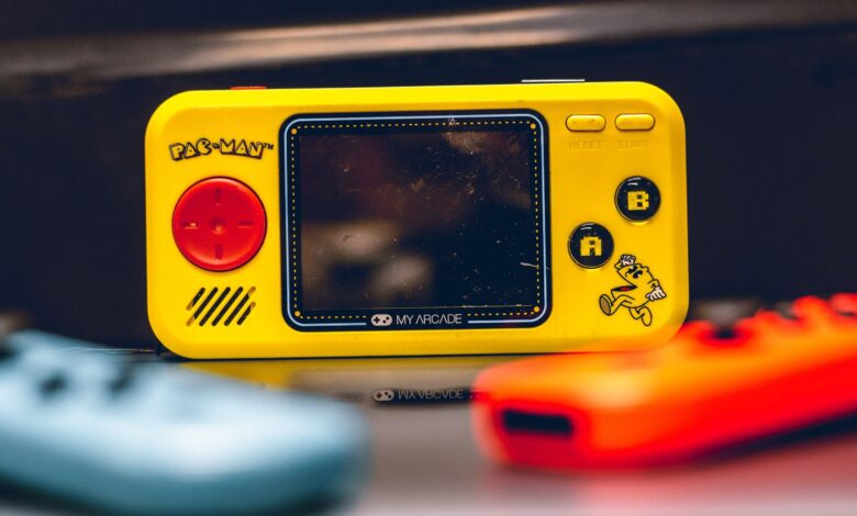 Colorful close-up of a Pac-Man themed My Arcade Pocket Player. Perfect for retro gaming enthusiasts.