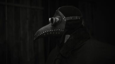 A haunting still life of a plague doctor mask in dark lighting, evoking historical and gothic themes.