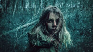A dramatic portrait of a distressed woman in a dark, eerie forest setting.