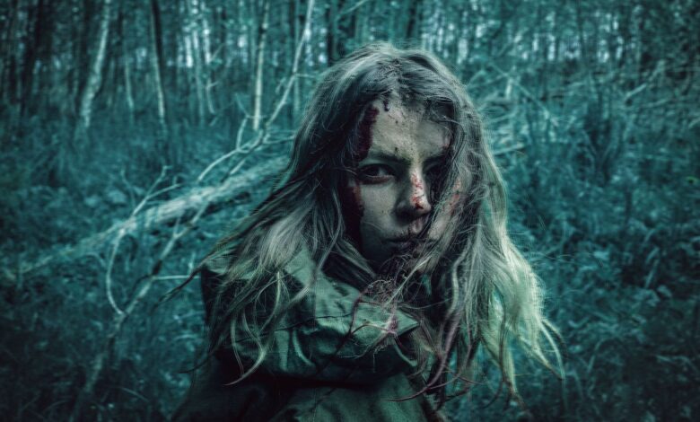 A dramatic portrait of a distressed woman in a dark, eerie forest setting.