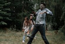 Terrifying zombies stumbling through a dark, creepy forest setting, perfect for horror themes.