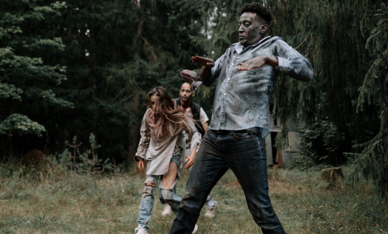 Terrifying zombies stumbling through a dark, creepy forest setting, perfect for horror themes.