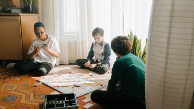 Three boys playing a strategic board game in a cozy indoor setting, emphasizing friendship and fun.