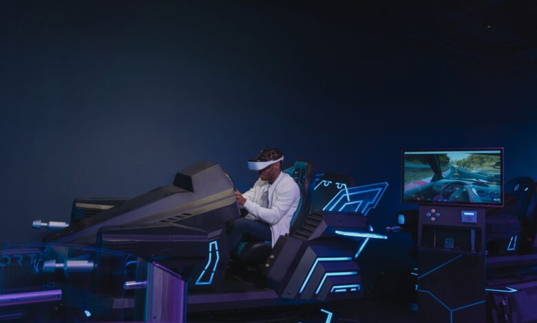 A young man immersed in a virtual reality driving simulation, wearing a VR headset indoors.