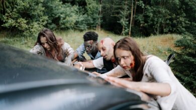 A group of zombies attack a car in a dense forest, creating a chilling, horror-filled scene.