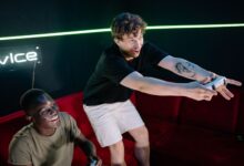Two young men having fun playing video games in a cozy indoor setting.