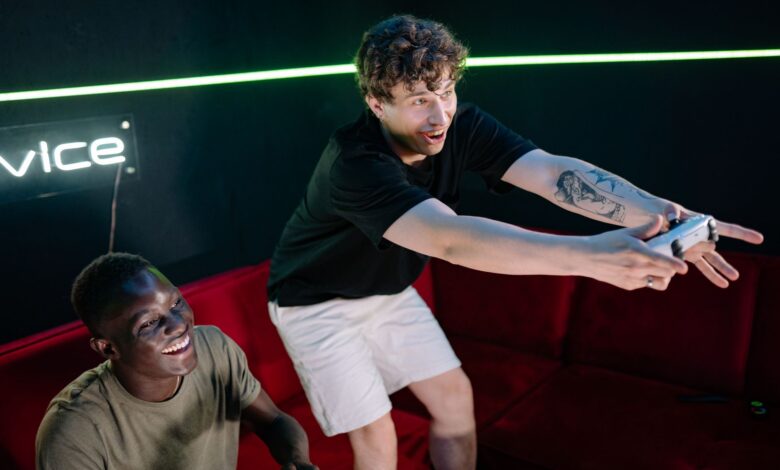 Two young men having fun playing video games in a cozy indoor setting.