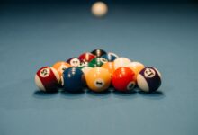 Close-up view of colorful billiard balls arranged for a pool game. Depth of field emphasizes the arrangement.