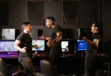 Enthusiastic group of diverse friends celebrating a gaming victory in an esports setting.