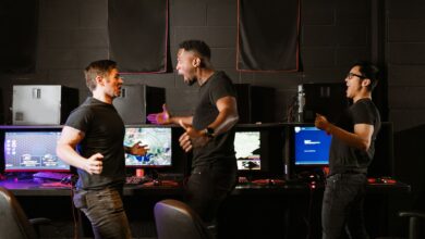 Enthusiastic group of diverse friends celebrating a gaming victory in an esports setting.